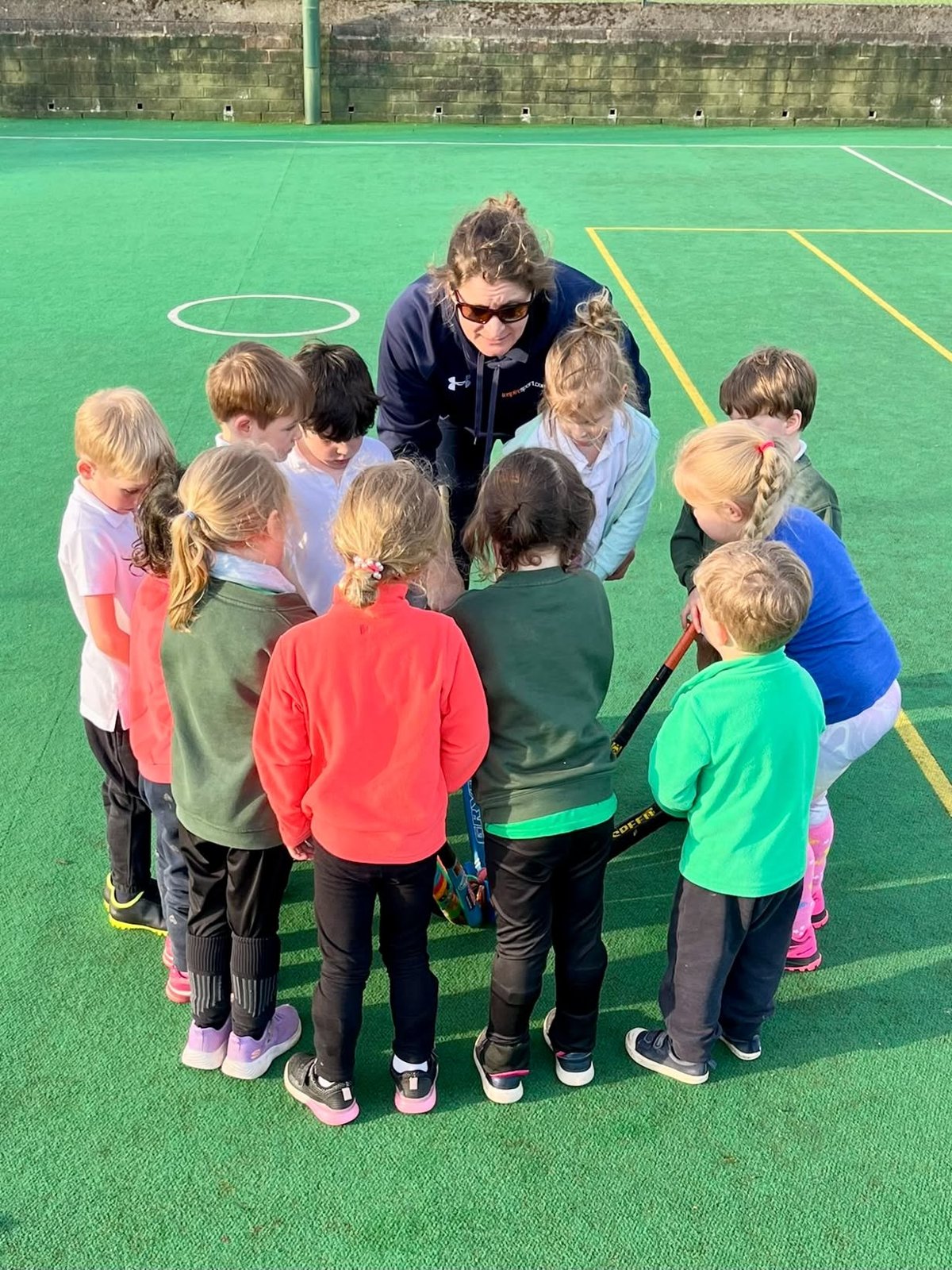Jessica in a huddle with young players