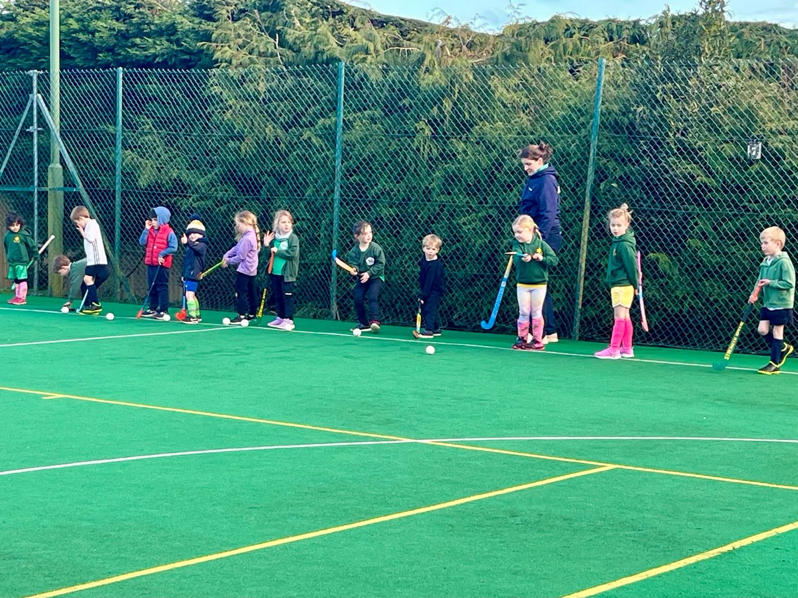 Young players lined up practising on the astro